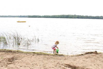Recomended Article: Where to find Rhinelander’s best beaches | Girl playing at Rhinelander beach