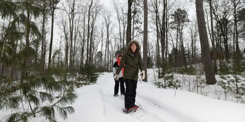 Friends snowshoeing Cavoc Trails