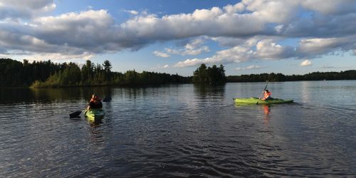Our favorite places to paddle in the Rhinelander Area | Two kayakers out on the water at West Bay Camping Resort