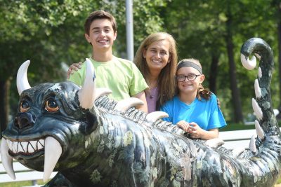 Recomended Article: How to spend an afternoon in Rhinelander | Family with Hodag statue outside Oneida County Courthouse Rhinelander WI