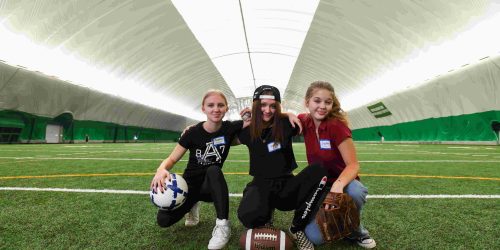 Escape the Chill: Rhinelander’s Winter Indoor Fun Guide | Girls posing for a picture at the Hodag Dome in Rhinelander